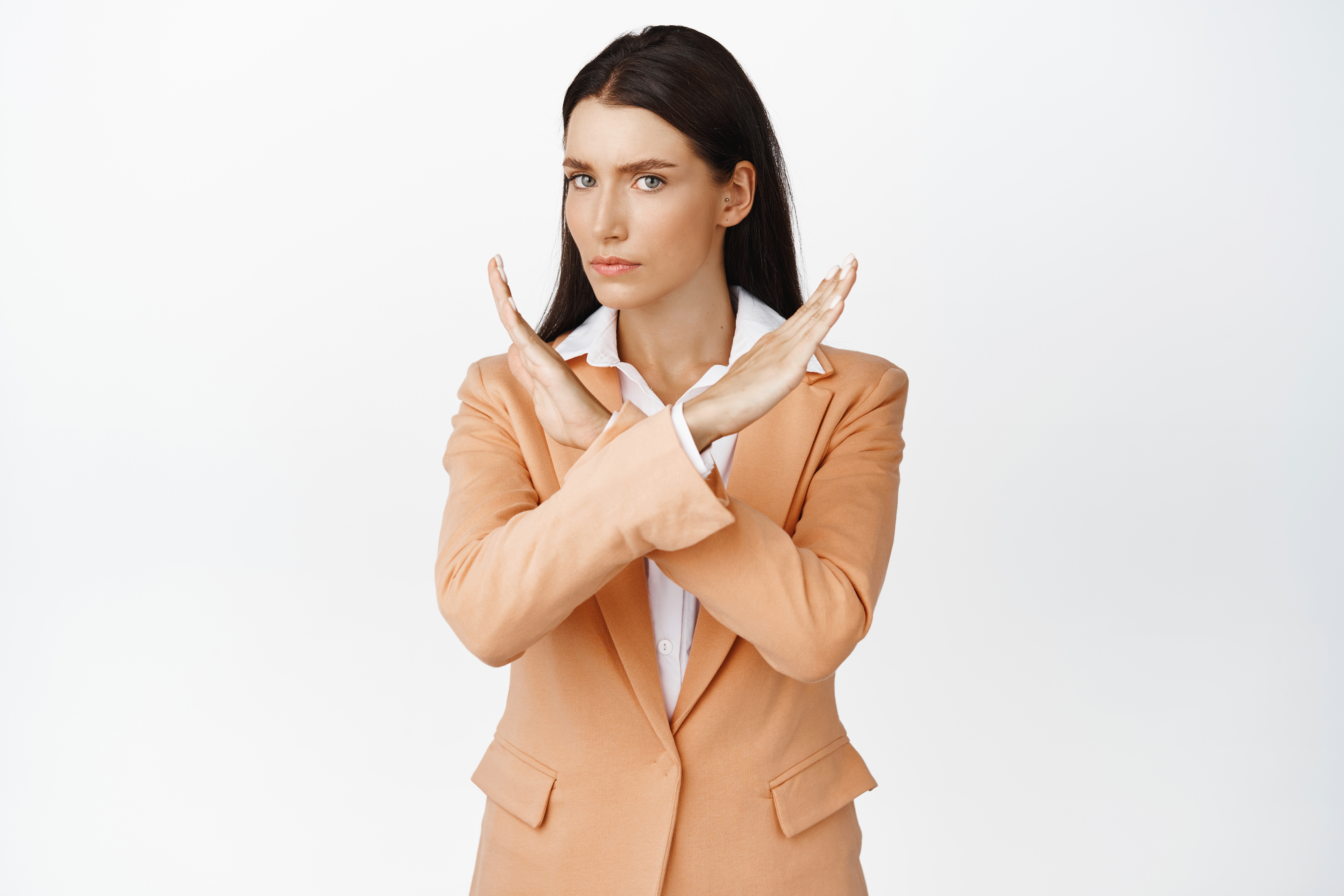 serious-concerned-corporate-woman-showing-cross-gesture-stopping-you-say-no-standing-suit-against-white-background.jpg