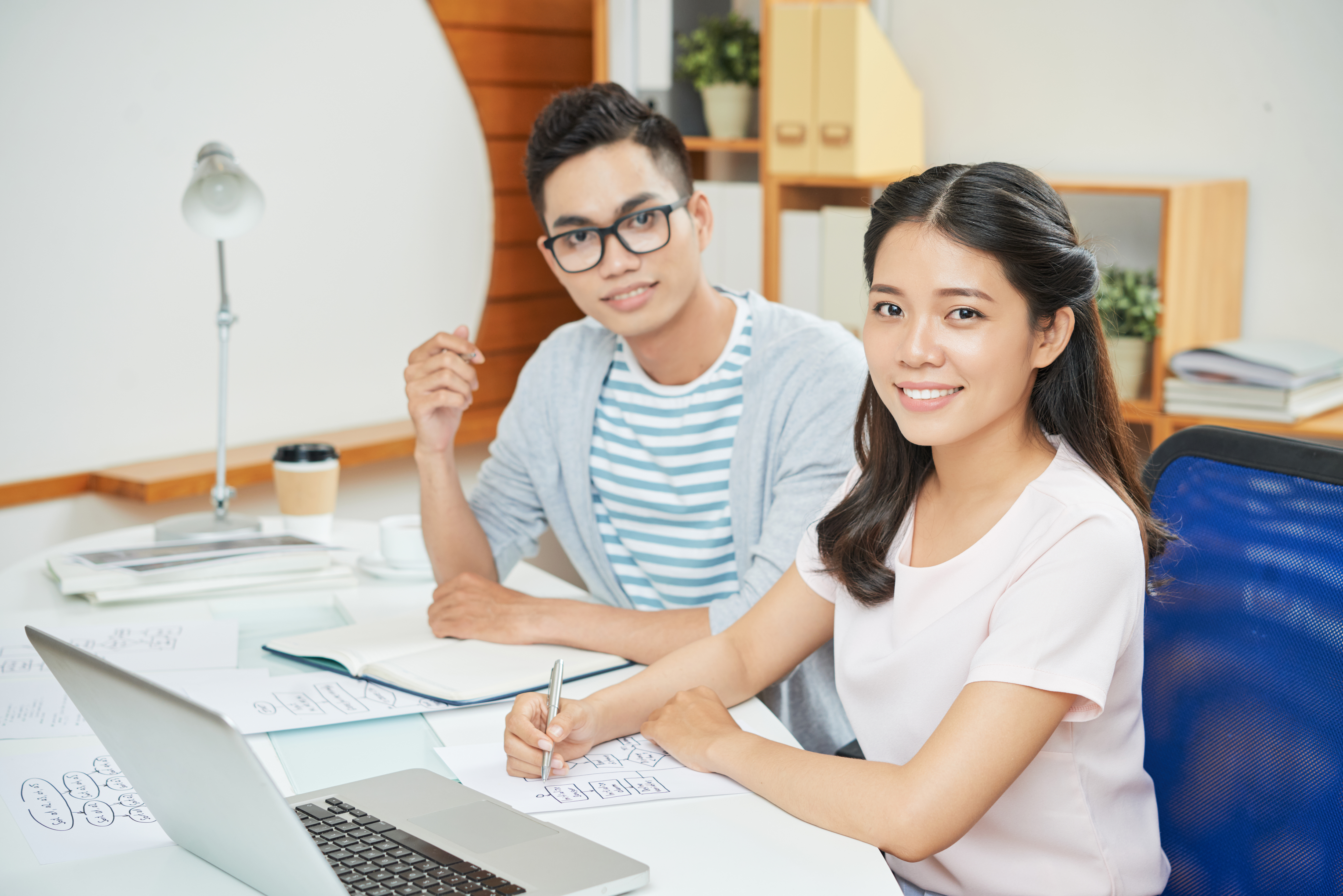 smiling-working-man-woman-desk.jpg